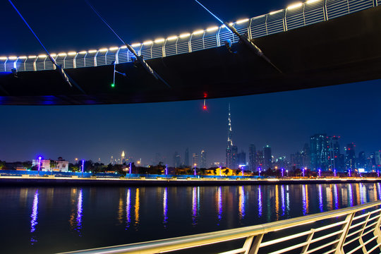 Dubai cityscape from the water canal bridge at night