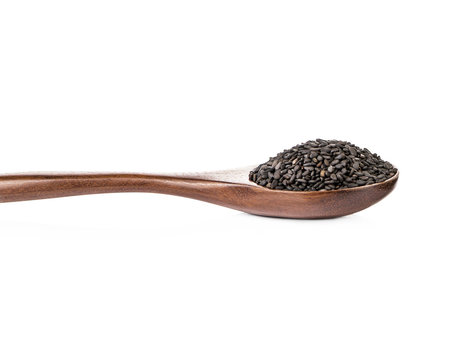 Wooden spoon with poppy seeds on a white background