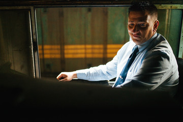 Young modern train driver in the cab of an old diesel locomotive