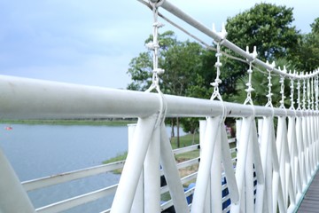 White suspension bridge in the park