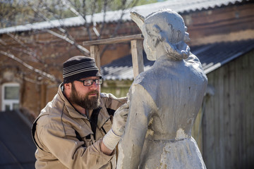 Renovator is engaged in the restoration of the statue