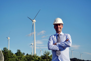 Portrait an engineer controls the functioning of wind turbines that run thanks to the force of the...