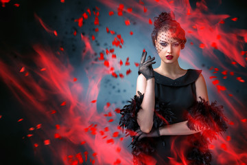 Abstract fashion portrait of young woman with flame