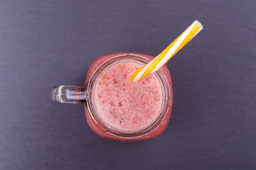 Healthy eating, food, dieting and vegetarian concept - glass of smoothies from strawberries, raspberries and banana, close up
