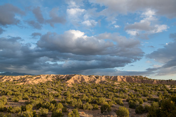 Dramatic evening sky and clouds over desert and badlands near Santa Fe, New Mexico