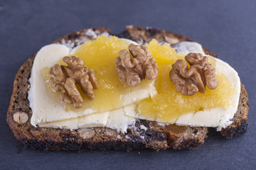 Sandwich of unleavened bread with butter, cheese, honey and walnuts