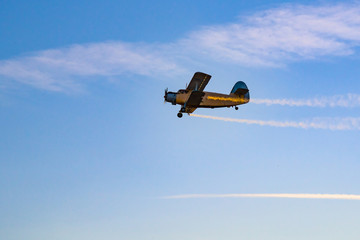 Biplane flying in the sunset