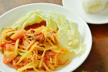 Som tum Thai spicy green papaya with pickled mussel salad eat couple sticky rice on plate