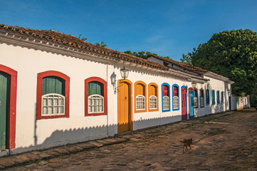 Cobblestone street with old houses under blue sunny sky in Paraty, a historic town totally preserved in the coast of the Rio de Janeiro State, southeastern Brazil