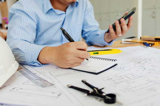 Engineer man working in the office, Drawing the construction project.