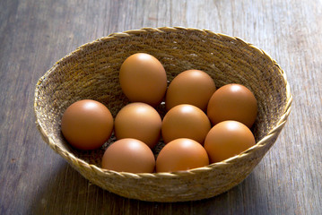 Egg in the basket on wood table.