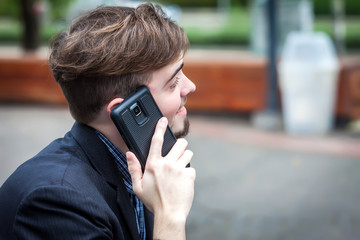 Young man talking on phone and smiling