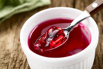 Eating red jelly or jello, spoonful of jelly on the top (Selective Focus, Focus in the middle of...