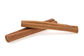 two cinnamon sticks on a white background