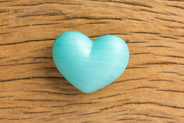 Blue heart shape over wooden table. Symbol of valentine day for background use. Concept of love and romance.