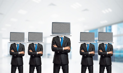 Businessmen with laptops instead of head.
