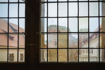 Old-fashioned window with a view of the castle