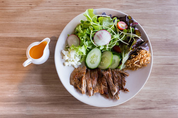 Luang Prabang Salad style with grilled pork served with yolk salad dressing.