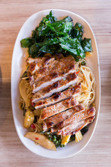 Drunken noodles: Spicy fried egg noodle with basil and pepper served with grilled pork.