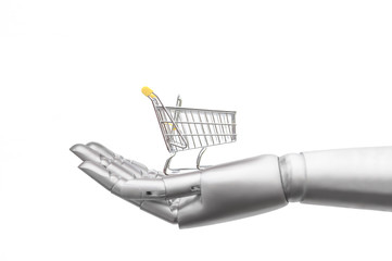 Ein Roboterarm hält einen leeren Einkaufswagen. Isoliert vor weißem Hintergrund. Zukunftsvision wie ein Roboter den Einkauf erledigt. - obrazy, fototapety, plakaty