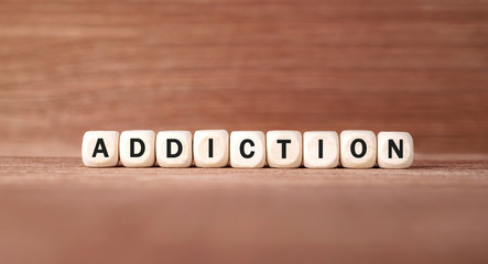 Word ADDICTION made with wood building blocks