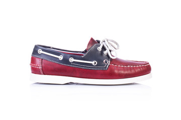 Close up of a red men topsider or boat shoes on white background with reflection. Fashion advertising shoes photos.
