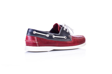 Close up of a red men topsider or boat shoes on white background with reflection. Fashion...