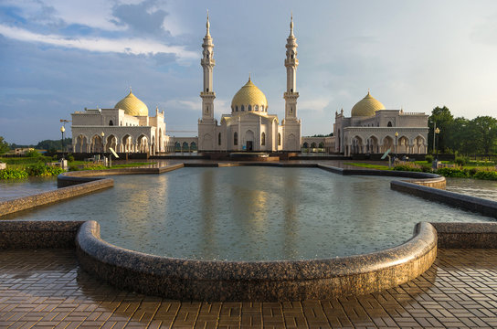 White mosque in Bolgar city after rain with reflection in the water and beautiful sky, Tatarstan, Russia