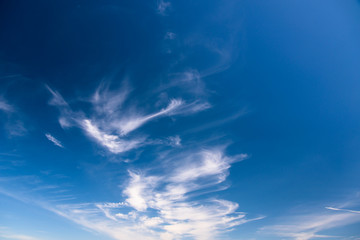 Naklejka na ściany i meble Spindrift clouds on blue sky