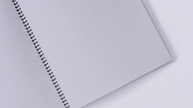 Turning binder book page in wind