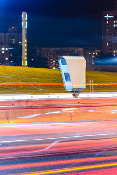 Stationary Car Speed Radar Near a Highway Road. Night Road Traffic Background