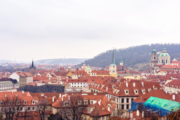 Obraz premium Cloudy day aerial view to clay pot roofs of Prague