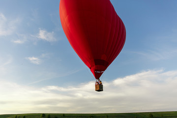 Red hot air balloon in the shape of a heart fly in sky. Love, honeymoon and romantic travel concept
