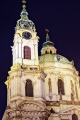 Fototapeta na wymiar St. Nicholas Church at night with warm lights on building