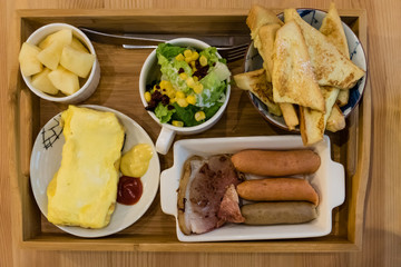 Sausage brunch with salad, egg, and french toast