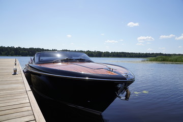 Luxury motorboat parked in the water on a sunny day