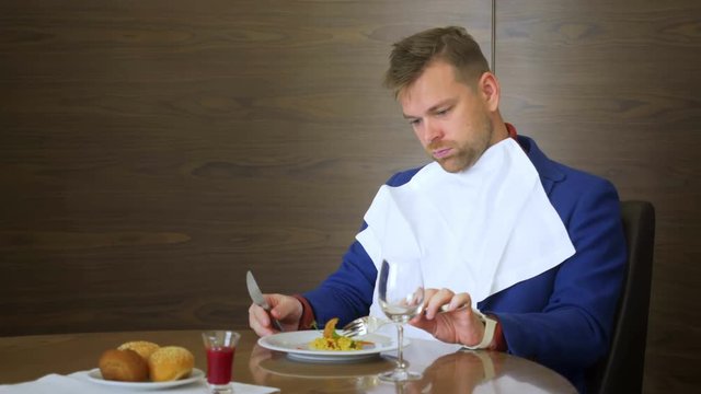 Dissatisfied restaurant critic looking on dish and does not want to try it