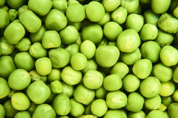 Fresh green peas background texture top view
