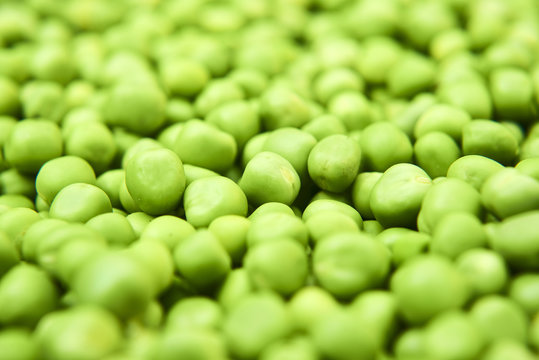 Fresh green peas background texture top view
