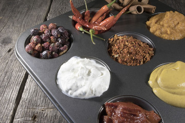 Different spices on plate pepper, mustard, sour cream, yogurt