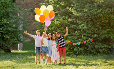 holidays, childhood and celebration concept - happy kids with balloons on birthday party at summer...
