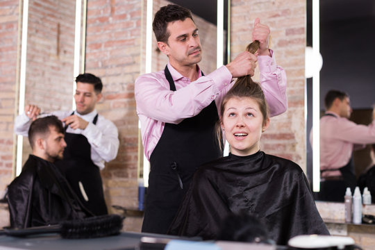 Man hairdresser discussing hairstyling with female client