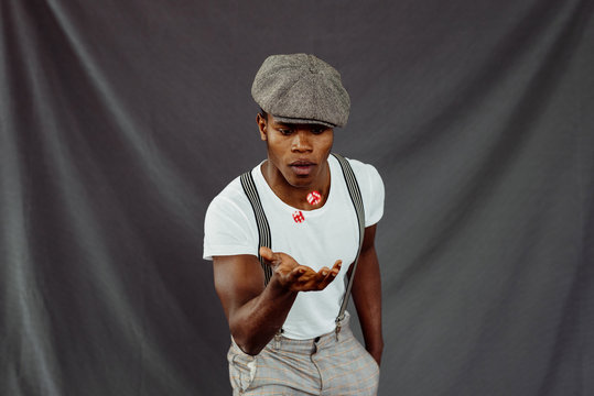 African-American man throwing up dices