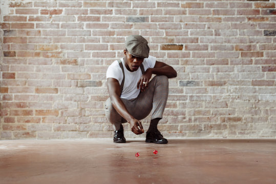 Man throwing dices on floor