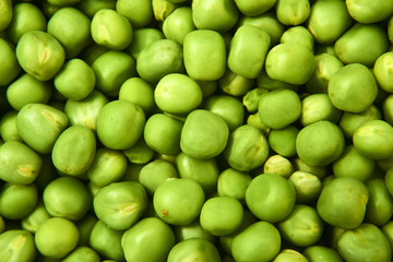 Fresh green peas background texture top view
