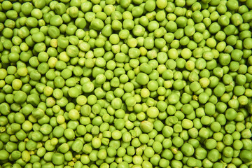 Fresh green peas background texture top view
