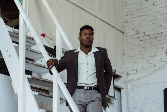 Black Man Standing On Ladder