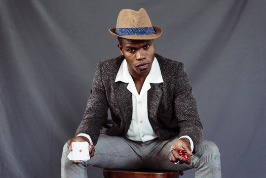 Man with playing card throwing dices