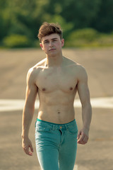 Young adult male shirtless outdoors