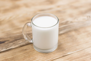 Glass kefir (milk) on a wooden background. The concept of diet, weight loss.